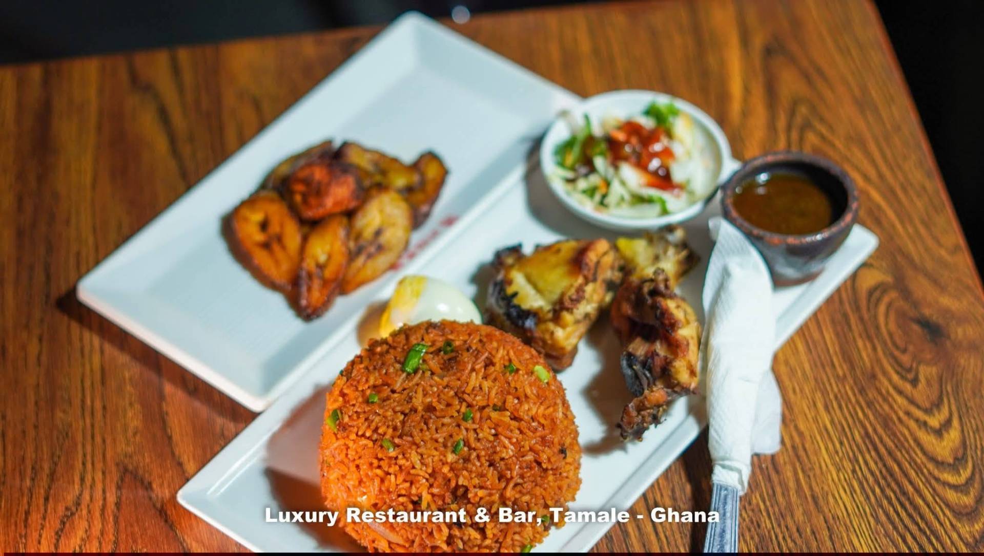Jollof rice with grilled chicken and plantain, a signature plate